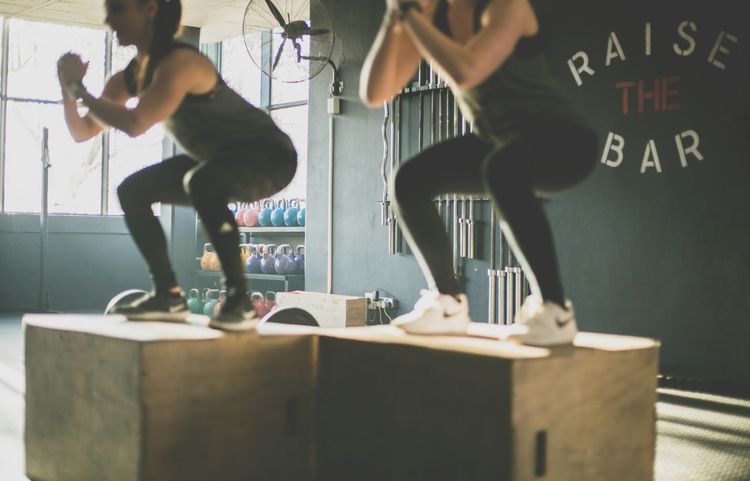 Partners performing box jumps